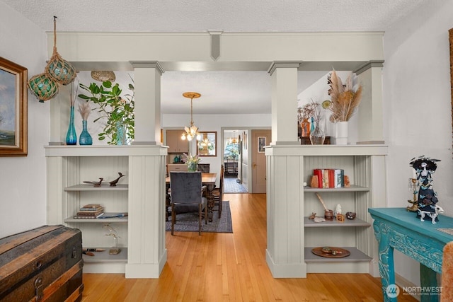 2914 N 15th St, Tacoma, WA 98406 - hallway featuring wood finished floors, a textured ceiling, and a chandelier