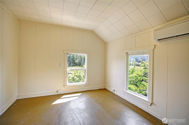 522 Chapman Rd, Camano Island, WA 98282 - spare room with a wall unit AC, a decorative wall, and vaulted ceiling