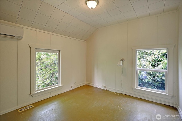522 Chapman Rd, Camano Island, WA 98282 - unfurnished room with a wall mounted AC, a decorative wall, concrete flooring, and vaulted ceiling