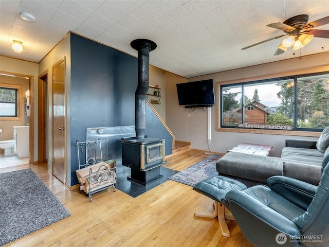 291 Hadaller Rd, Mossyrock, WA 98564 - living area with a wood stove, a ceiling fan, and wood finished floors