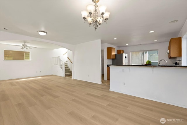 331 Index Ave SE, Renton, WA 98056 - unfurnished living room featuring light wood-type flooring, stairway, ceiling fan, recessed lighting, and arched walkways