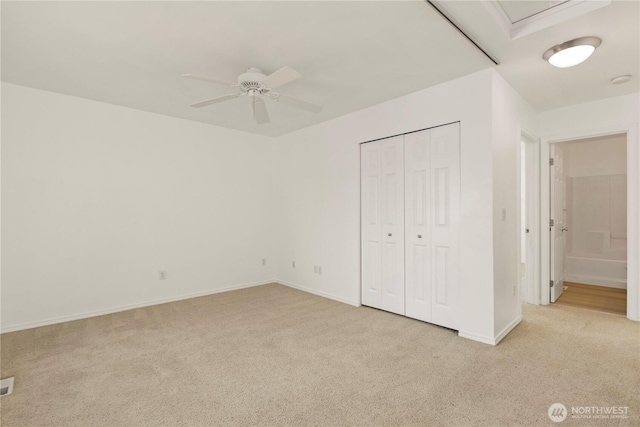 331 Index Ave SE, Renton, WA 98056 - unfurnished bedroom with light carpet, a closet, and a ceiling fan