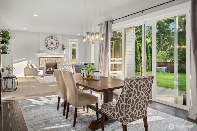 2283 244th Ave SE, Sammamish, WA 98075 - dining room featuring plenty of natural light, recessed lighting, a fireplace, a chandelier, and wood finished floors
