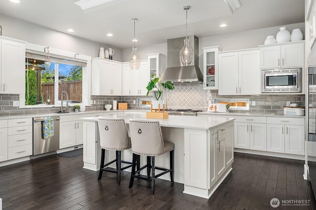 2283 244th Ave SE, Sammamish, WA 98075 - kitchen with wall chimney range hood, stainless steel appliances, a center island, white cabinets, and recessed lighting