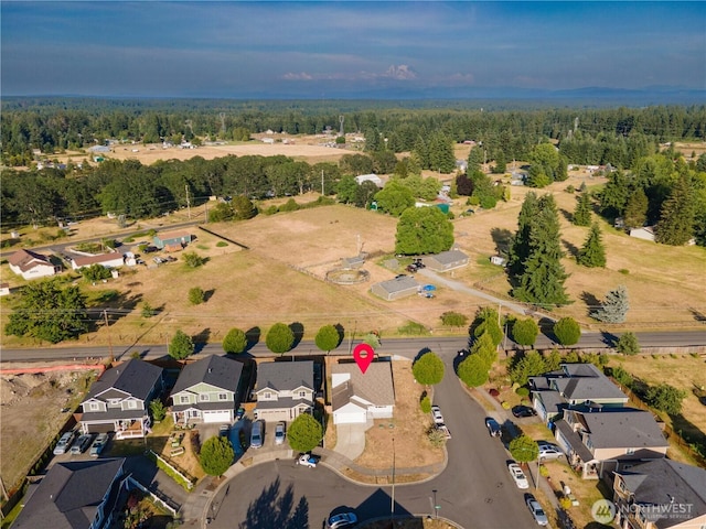9960 Locust Ct SE, Yelm, WA 98597 - aerial overview of property's location with nearby suburban area and a heavily wooded area