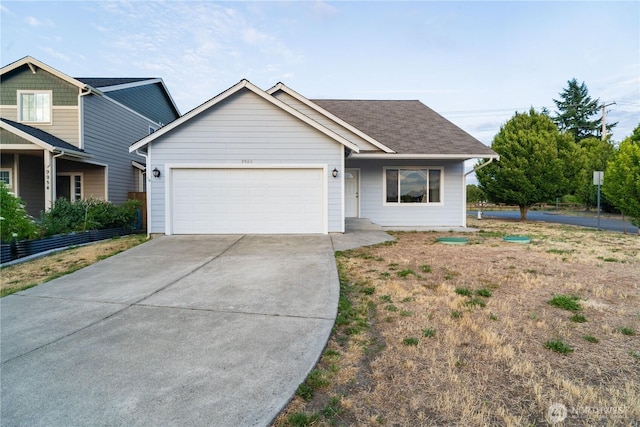9960 Locust Ct SE, Yelm, WA 98597 - view of front facade featuring a garage, concrete driveway, and a shingled roof