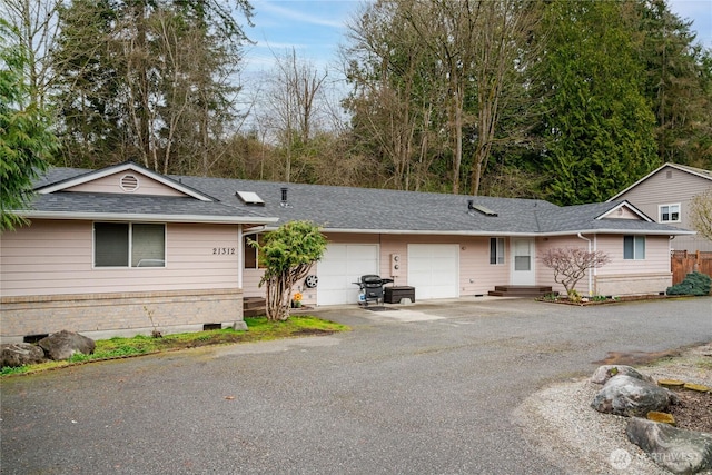 21312 87th Ave NE Unit 1 & 2, Arlington, WA 98223 - single story home featuring an attached garage, asphalt driveway, and a shingled roof