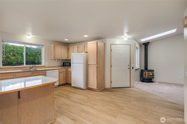 21312 87th Ave NE Unit 1 & 2, Arlington, WA 98223 - kitchen featuring white appliances, light countertops, light brown cabinets, a wood stove, and light wood finished floors