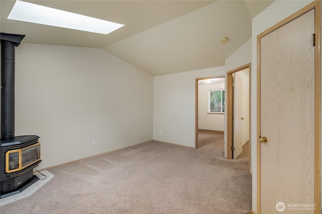 21312 87th Ave NE Unit 1 & 2, Arlington, WA 98223 - unfurnished living room featuring a skylight, light carpet, lofted ceiling, and a wood stove