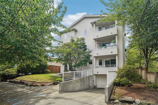 1707 NW 59th St Unit 302, Seattle, WA 98107 - view of building exterior with a garage and driveway