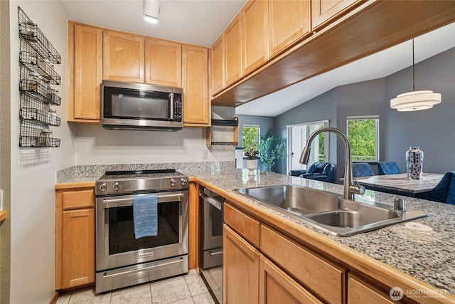1707 NW 59th St Unit 302, Seattle, WA 98107 - kitchen featuring stainless steel appliances, light countertops, lofted ceiling, light tile patterned flooring, and hanging light fixtures