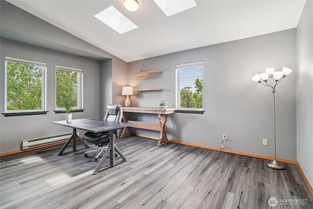 1707 NW 59th St Unit 302, Seattle, WA 98107 - home office featuring a baseboard radiator, wood finished floors, a skylight, and lofted ceiling