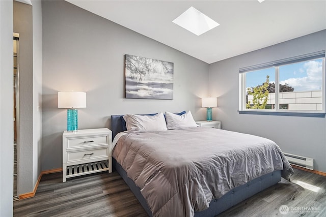 1707 NW 59th St Unit 302, Seattle, WA 98107 - bedroom with a baseboard radiator, vaulted ceiling, a skylight, and wood finished floors