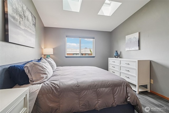 1707 NW 59th St Unit 302, Seattle, WA 98107 - bedroom featuring wood finished floors, a skylight, and vaulted ceiling