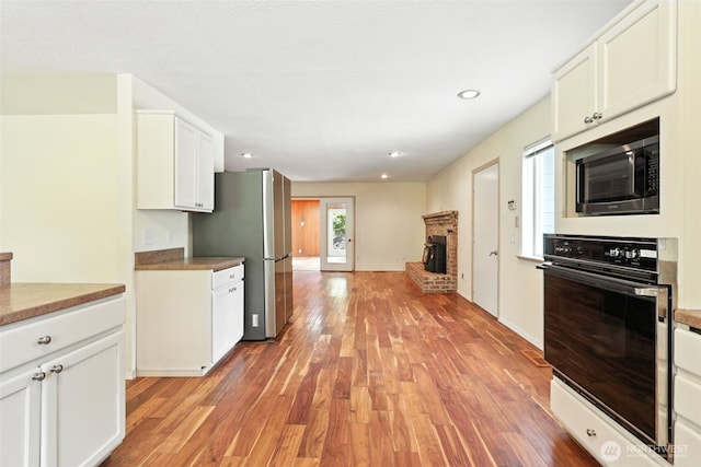 116 Noble Rd, Winlock, WA 98596 - kitchen featuring stainless steel appliances, light wood-type flooring, white cabinetry, recessed lighting, and light countertops