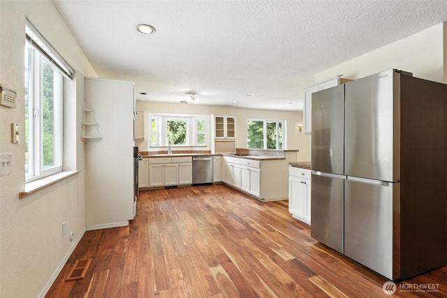 116 Noble Rd, Winlock, WA 98596 - kitchen featuring appliances with stainless steel finishes, wood finished floors, white cabinetry, and recessed lighting