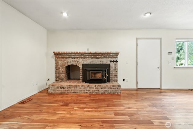116 Noble Rd, Winlock, WA 98596 - unfurnished living room featuring light wood finished floors, a brick fireplace, and recessed lighting