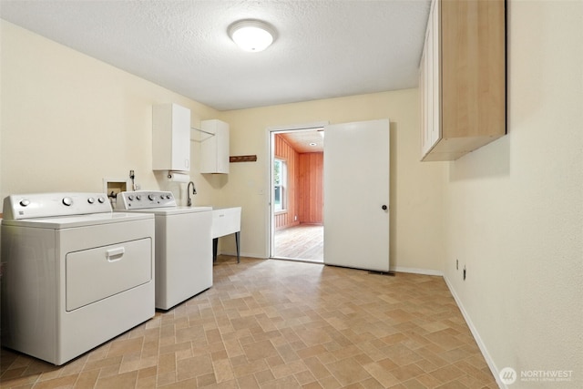 116 Noble Rd, Winlock, WA 98596 - washroom featuring washer and clothes dryer, cabinet space, and a textured ceiling