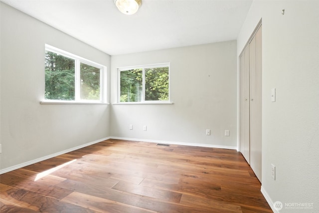 116 Noble Rd, Winlock, WA 98596 - unfurnished bedroom featuring multiple windows, wood finished floors, and a closet