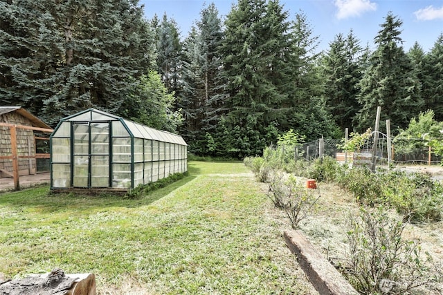 116 Noble Rd, Winlock, WA 98596 - view of yard featuring an exterior structure, an outbuilding, a garden, and a wooded view