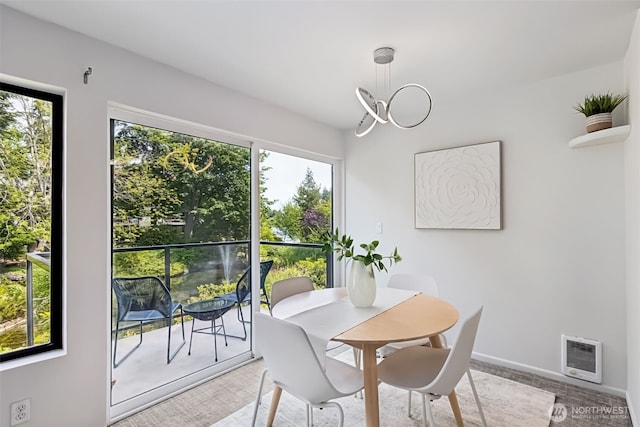 19414 Aurora Ave N Unit 203, Shoreline, WA 98133 - dining space featuring heating unit, a chandelier, and light colored carpet