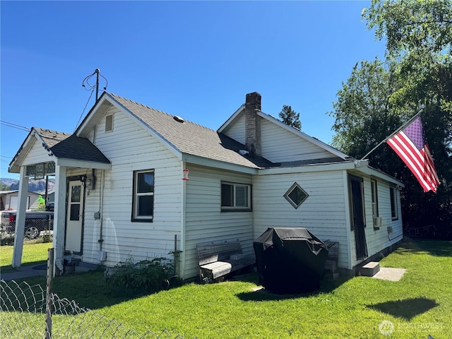 1105 Central Ave, Oroville, WA 98844 - back of property with a lawn, a chimney, and roof with shingles
