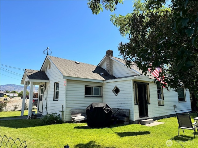 1105 Central Ave, Oroville, WA 98844 - back of house featuring a lawn, a chimney, and a mountain view