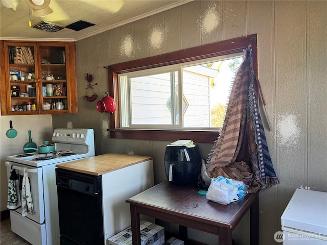 1105 Central Ave, Oroville, WA 98844 - kitchen with white electric range oven, black dishwasher, healthy amount of natural light, crown molding, and light countertops
