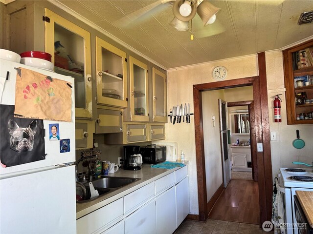 1105 Central Ave, Oroville, WA 98844 - kitchen featuring white appliances, ceiling fan, light countertops, and glass insert cabinets
