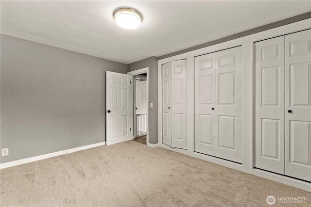 12027 78th Ave S, Seattle, WA 98178 - unfurnished bedroom featuring carpet floors and multiple closets