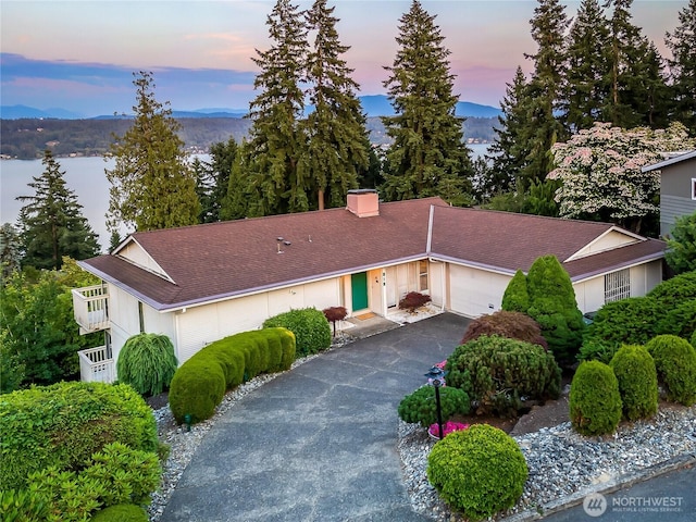818 179th Pl NE, Bellevue, WA 98008 - view of front facade with asphalt driveway, an attached garage, and roof with shingles