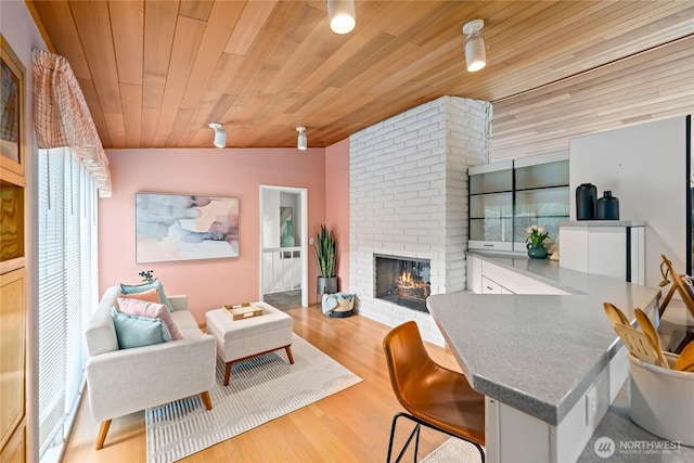 818 179th Pl NE, Bellevue, WA 98008 - living room with wood ceiling, a brick fireplace, and wood finished floors