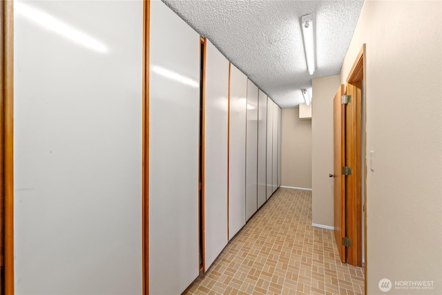 818 179th Pl NE, Bellevue, WA 98008 - corridor featuring a textured ceiling and baseboards