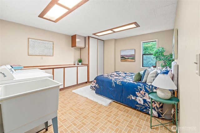818 179th Pl NE, Bellevue, WA 98008 - bedroom featuring washing machine and clothes dryer and brick patterned flooring