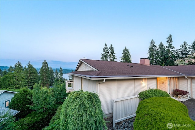 818 179th Pl NE, Bellevue, WA 98008 - view of home's exterior with a garage and a chimney