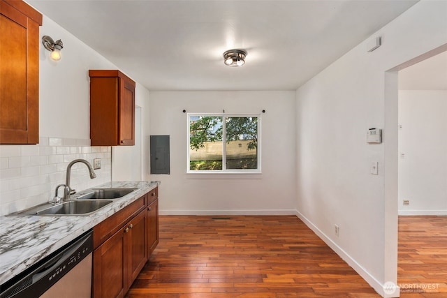 2033 E Wright Ave, Tacoma, WA 98404 - kitchen featuring stainless steel dishwasher, electric panel, dark wood-style floors, light countertops, and brown cabinetry