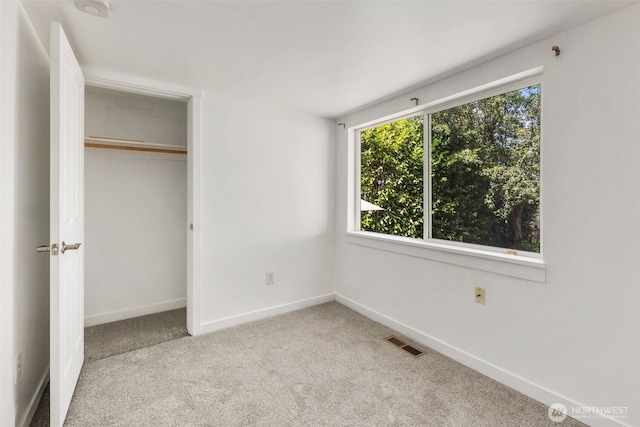 2033 E Wright Ave, Tacoma, WA 98404 - unfurnished bedroom featuring carpet, multiple windows, and a closet