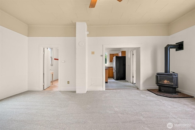 1609 F St, Bellingham, WA 98225 - unfurnished living room with a wood stove, light carpet, and ceiling fan