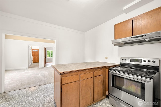 1609 F St, Bellingham, WA 98225 - kitchen with stainless steel electric stove, under cabinet range hood, a peninsula, brown cabinetry, and tile counters