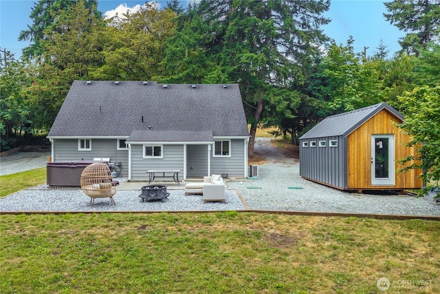 4415 Waller Rd E, Tacoma, WA 98443 - rear view of property with an outdoor fire pit, a lawn, a patio, an outbuilding, and a shingled roof