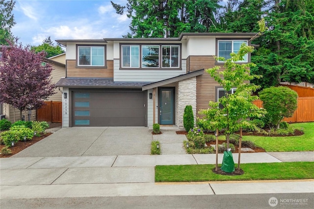 10259 133rd Ct NE, Redmond, WA 98033 - contemporary home featuring concrete driveway, a garage, and stone siding