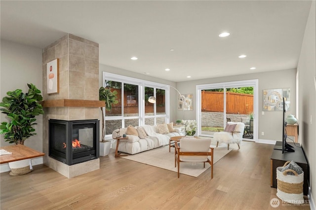 10259 133rd Ct NE, Redmond, WA 98033 - living room featuring wood finished floors, a multi sided fireplace, and recessed lighting