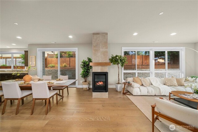 10259 133rd Ct NE, Redmond, WA 98033 - living area with light wood-style flooring, recessed lighting, and a fireplace