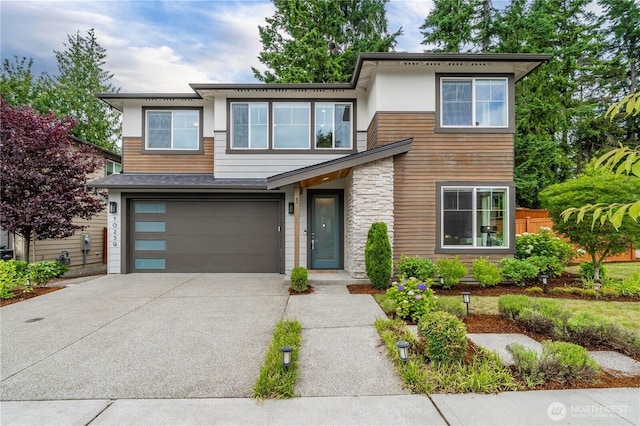 10259 133rd Ct NE, Redmond, WA 98033 - contemporary house featuring concrete driveway, a garage, and stone siding