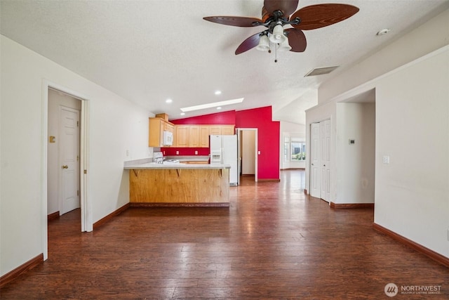 87 Chickadee Dr, Kelso, WA 98626 - kitchen featuring white appliances, a peninsula, lofted ceiling, dark wood finished floors, and light countertops