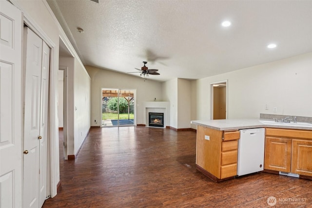 87 Chickadee Dr, Kelso, WA 98626 - kitchen featuring dishwasher, ceiling fan, dark wood finished floors, a glass covered fireplace, and a textured ceiling