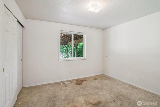 87 Chickadee Dr, Kelso, WA 98626 - unfurnished bedroom featuring carpet floors, a closet, and a textured ceiling