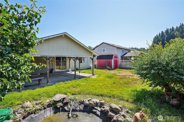 87 Chickadee Dr, Kelso, WA 98626 - back of house featuring a storage unit and a patio