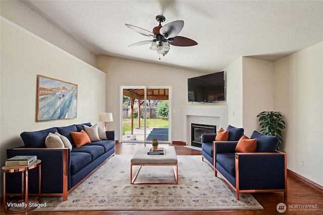 87 Chickadee Dr, Kelso, WA 98626 - living area featuring vaulted ceiling, wood finished floors, a ceiling fan, and a fireplace with flush hearth