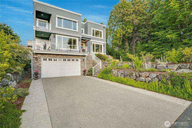 1425 S Sunset Dr, Tacoma, WA 98465 - modern home featuring a garage, stairway, concrete driveway, stucco siding, and stone siding